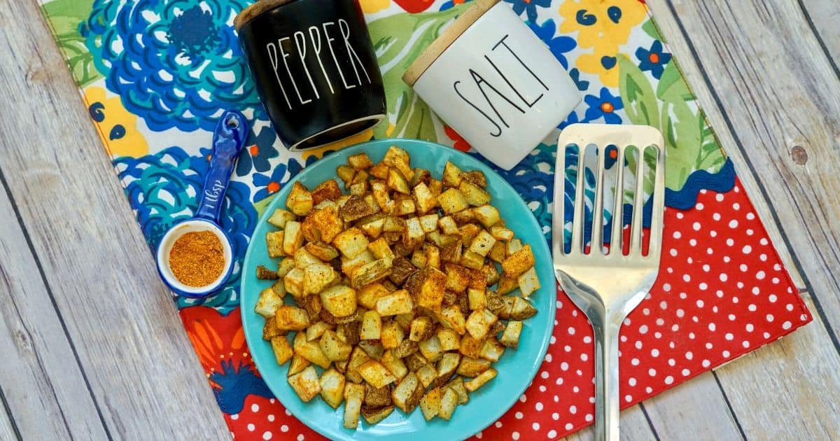 air fryer cajun diced potatoes on plate with other table decor