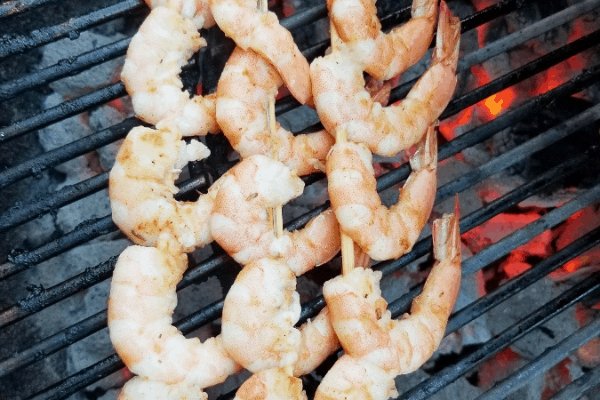 shrimp skewers cooking on grill