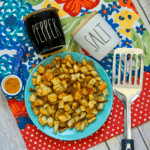 air fried cajun potatoes on plate with spatula and other kitchen decor