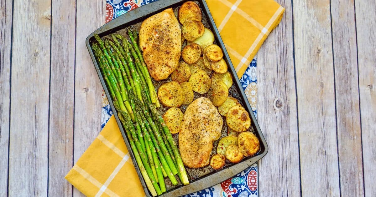 italian chicken dish on sheet pan with asparagus and potatoes
