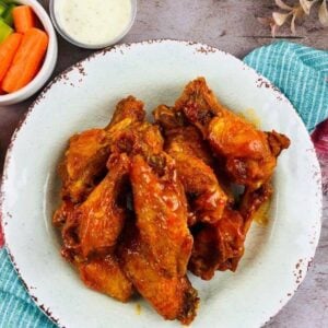 buffalo chicken wings on a plate with sides and dipping sauce