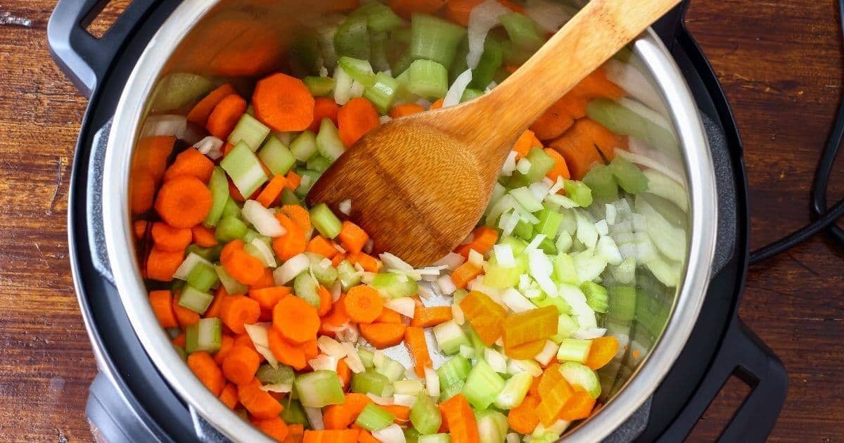 close up view of celery and carrots being cooked in an instant pot after doing a Slow Cooker to Instant Pot Conversion 