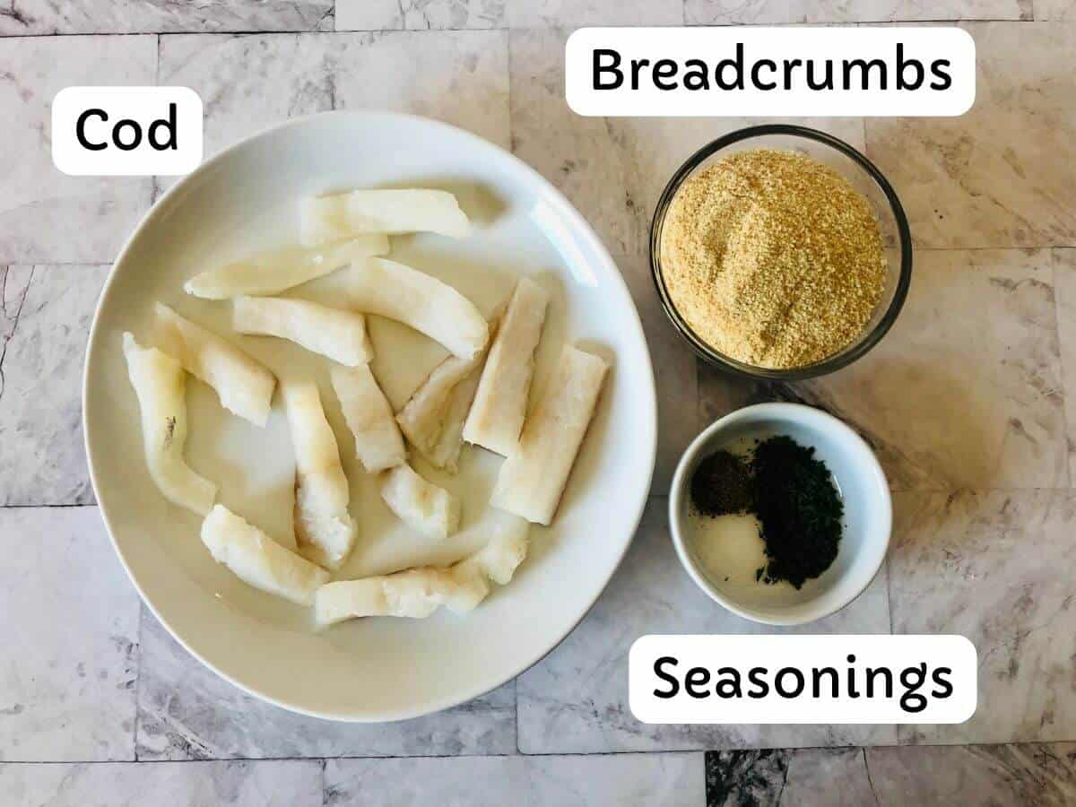 bowls of ingredients for fish sticks in the air fryer including labels: cod, breadcrumbs, seasonings.
