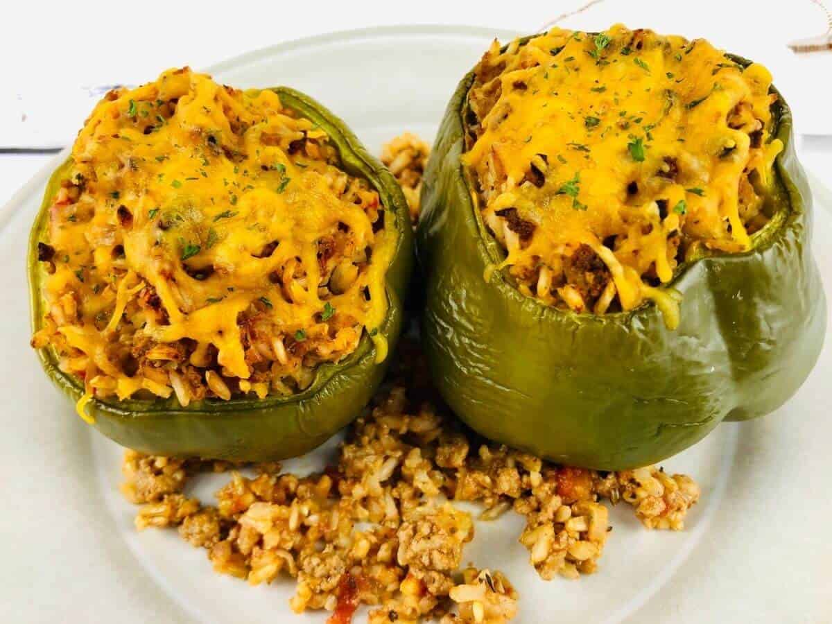 two air fryer stuffed peppers on a white plate.