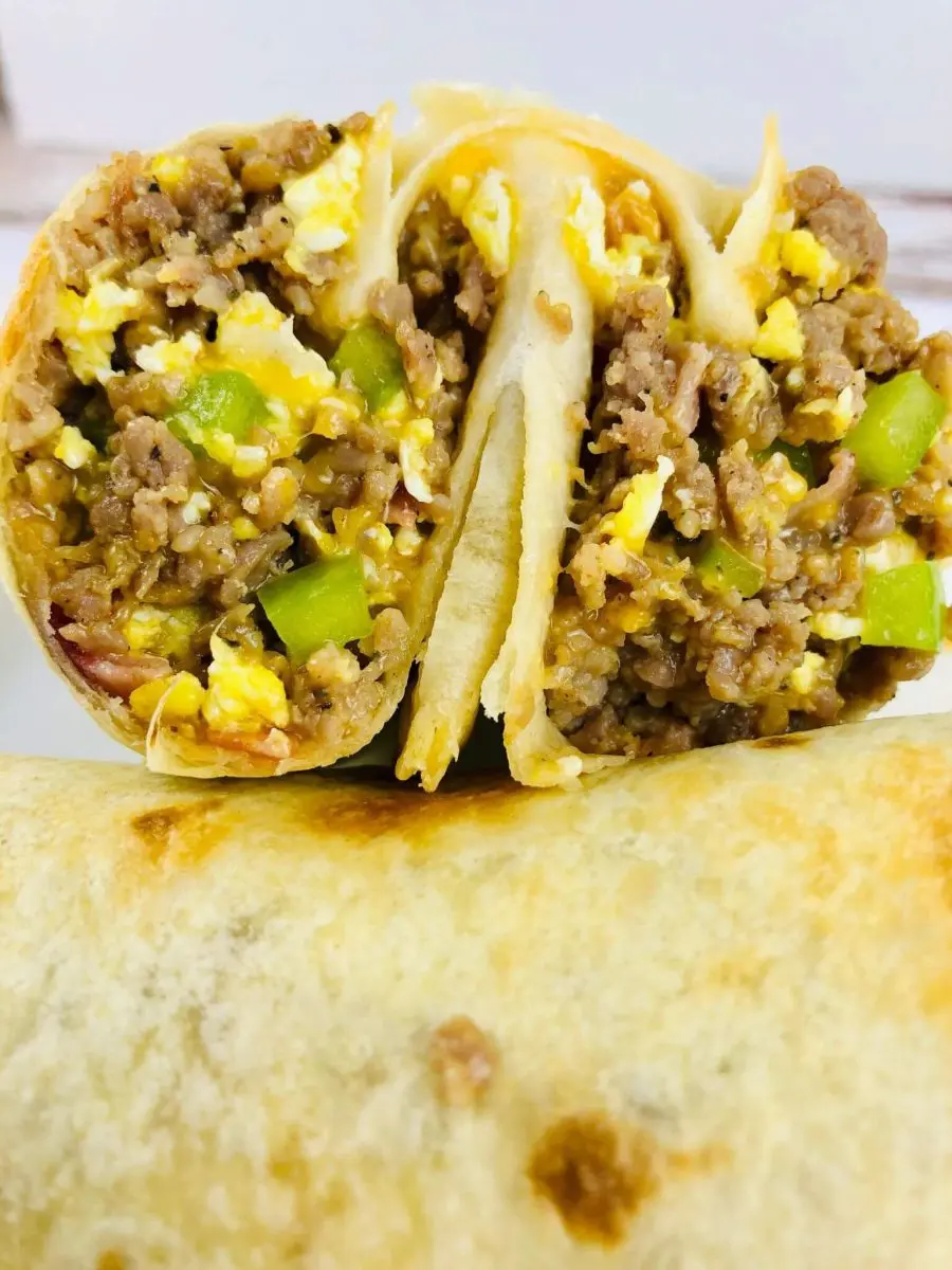 close up of air fryer breakfast burritos cut.