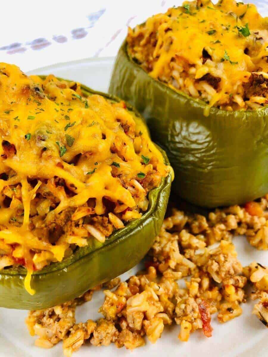 close up view of two air fryer stuffed peppers.