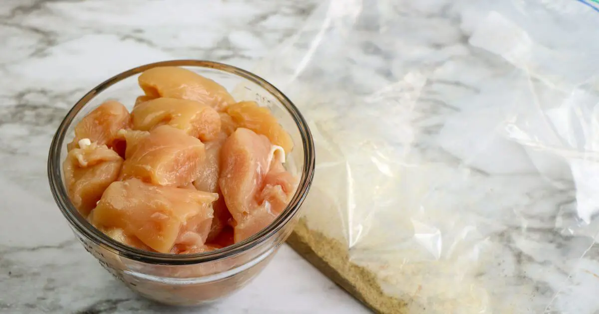 Raw cubed chicken in a bowl for Panda Express Black Pepper Chicken.