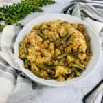 A white bowl filled with a 4 ingredient slow cooker chicken with stuffing dish.