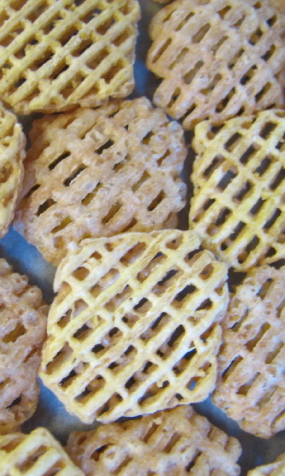 Close up of Crispix cereal on a blue background.