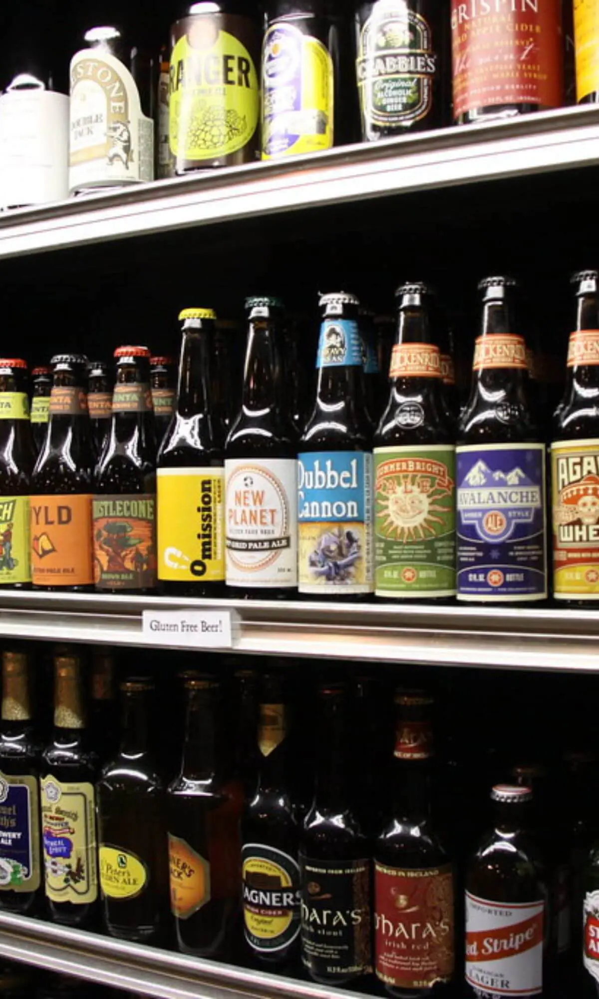 Gluten free beers, including omission on a store shelf.