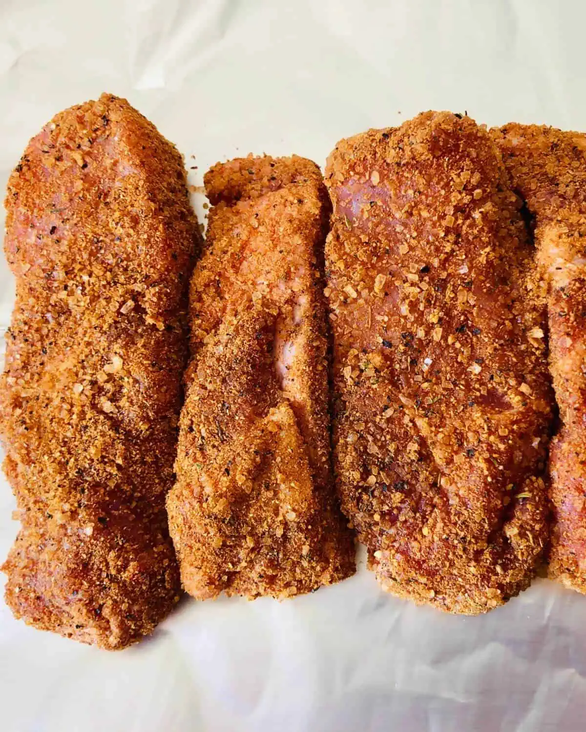 Pork ribs covered in dry rub seasoning.