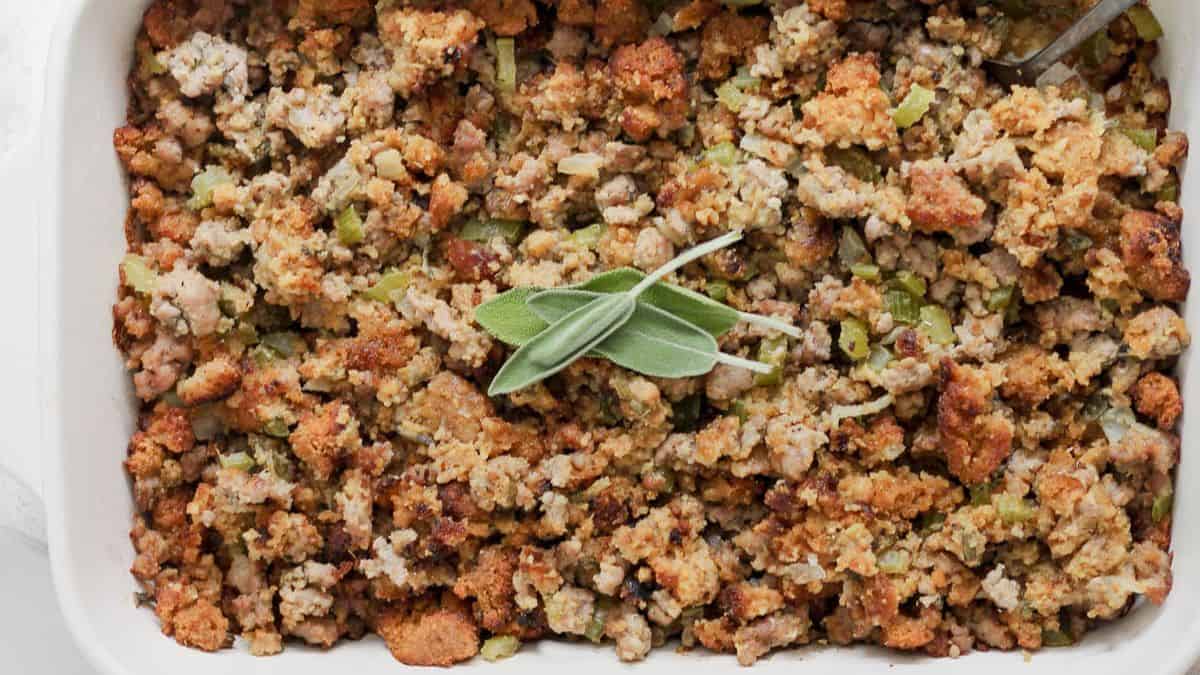 A casserole of cornbread stuffing with sage leaves on top