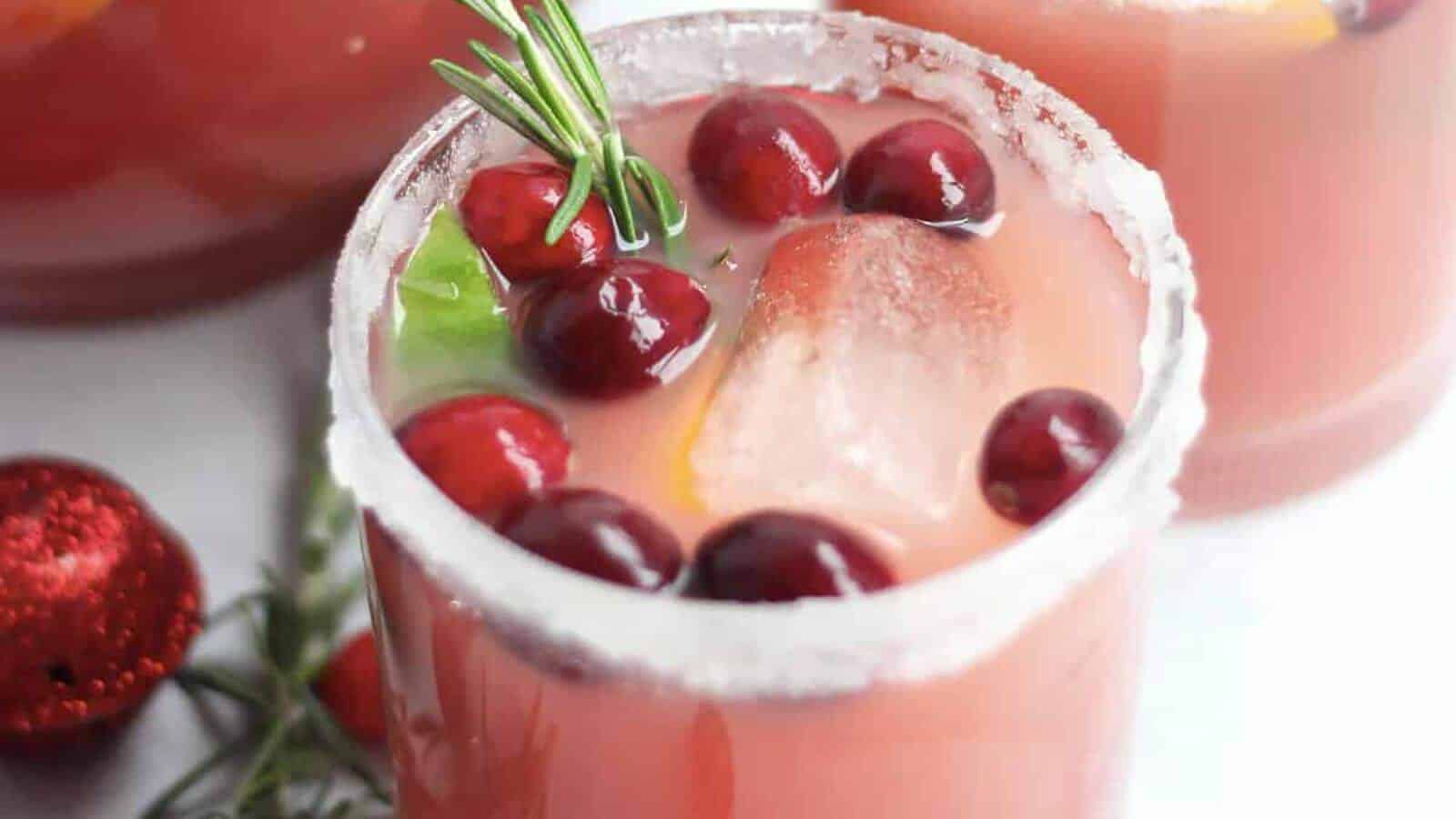 Cranberry orange ginger mocktail in a glass with cranberries.