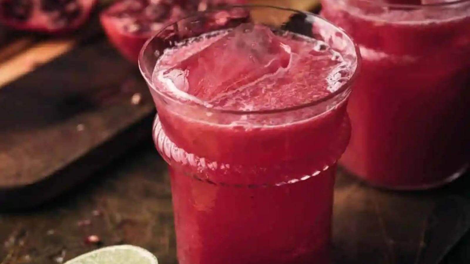 Pomegranate limeade in a glass with ice.