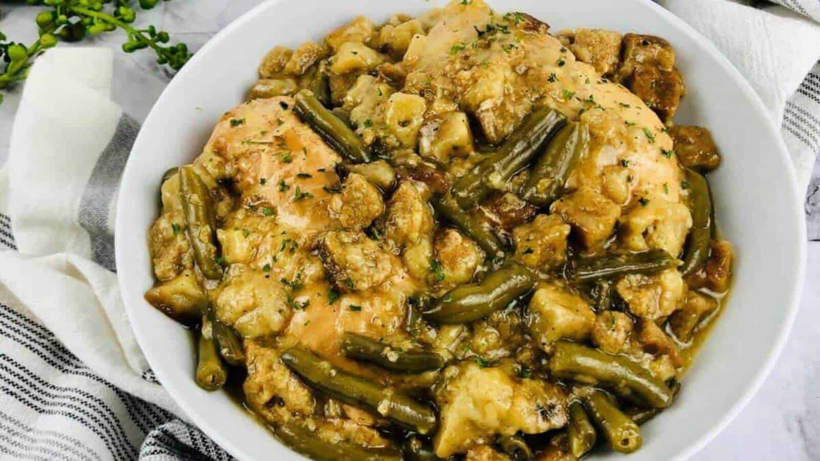 Gluten free chicken, stuffing and green beans in a white bowl.