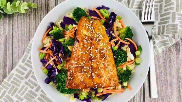 Gluten free teriyaki salmon in a white bowl with veggies.