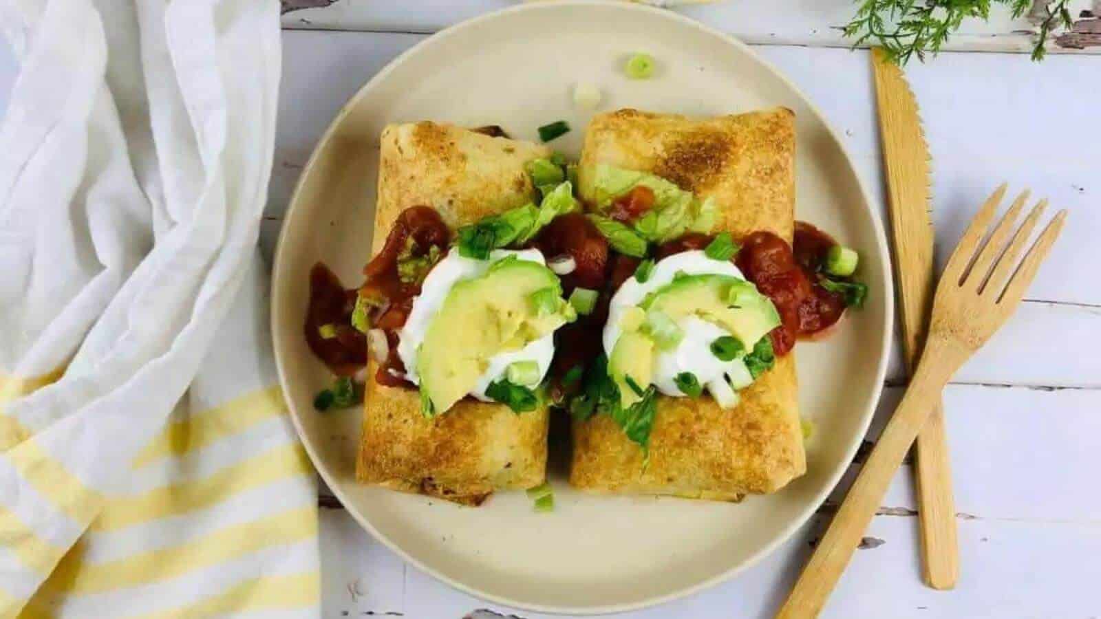 Two gluten free chimichangas on a plate.