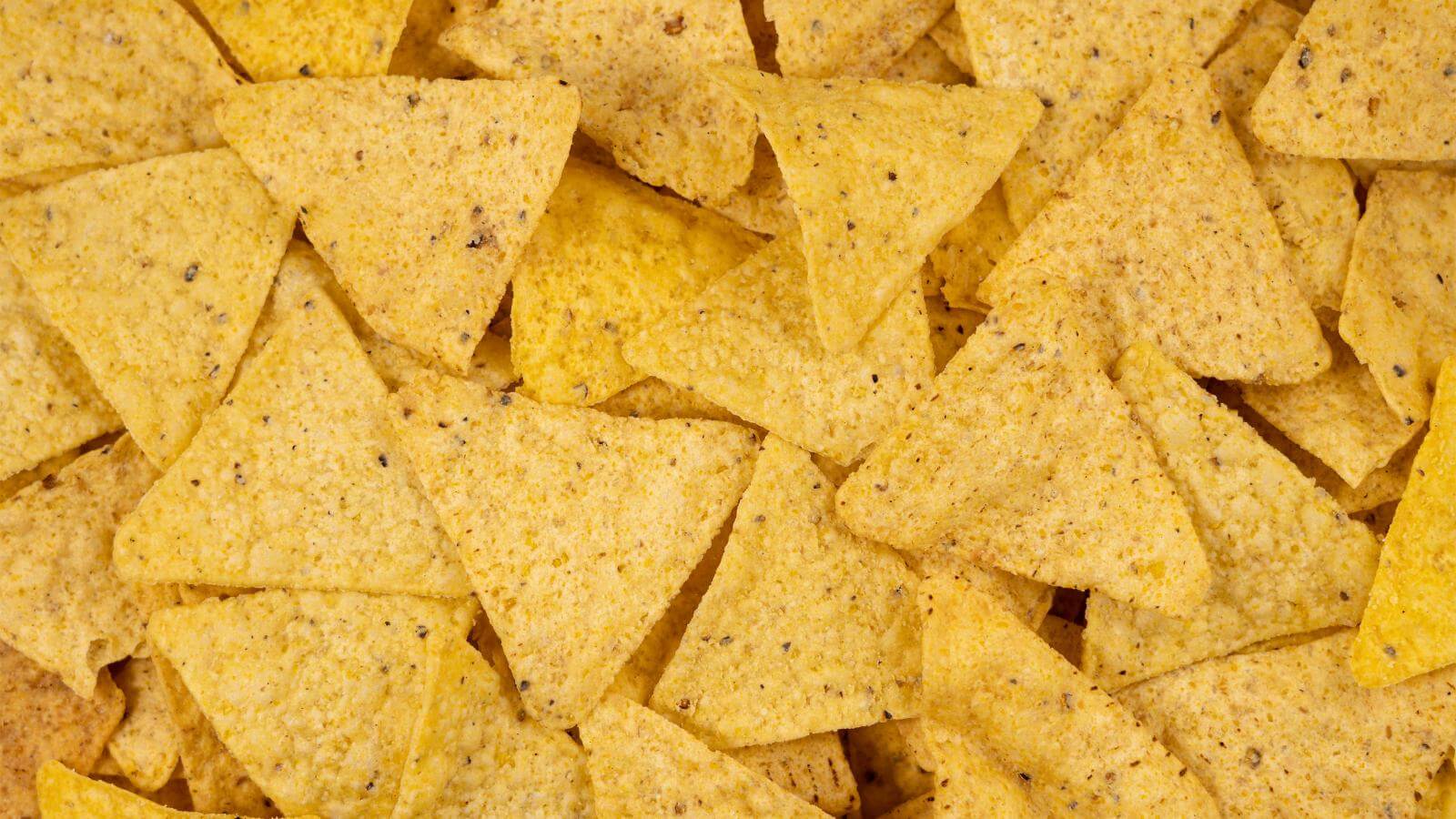 A large pile of corn tortilla chips.