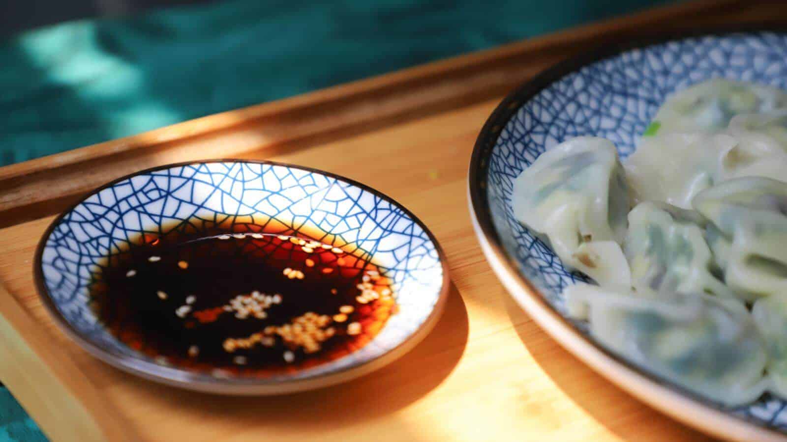 A small saucer full of soy sauce.