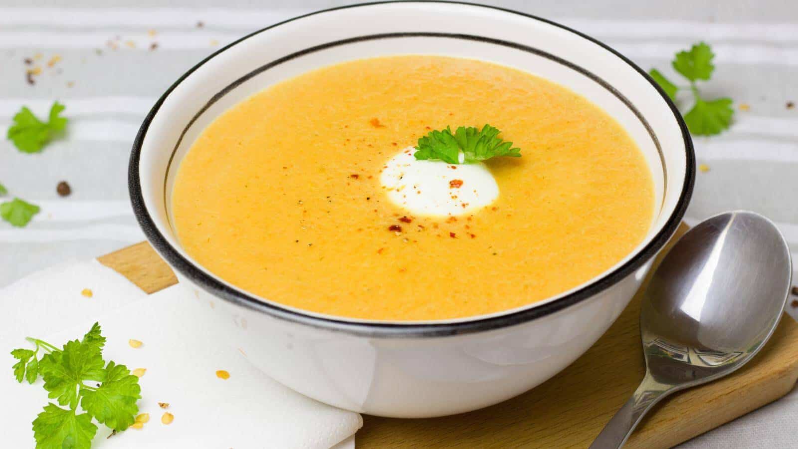 A bowl full of creamy yellow soup.