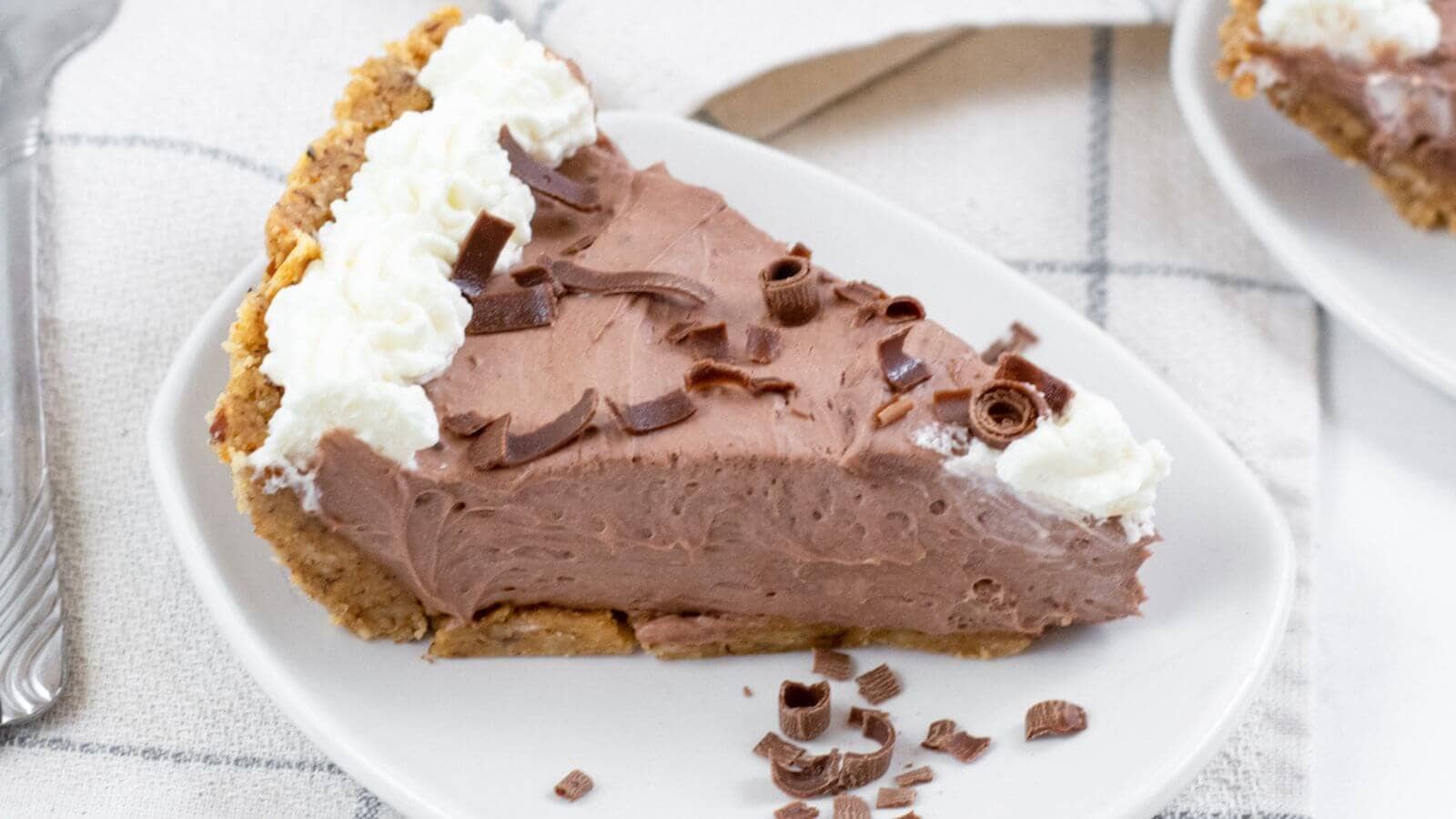 A slice of keto chocolate pudding pie on a plate.