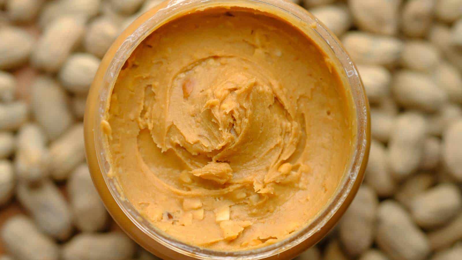A close up view of the inside of a jar of peanut butter.