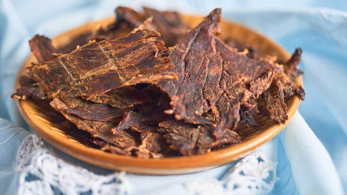 A bowl full of pieces of beef jerky.