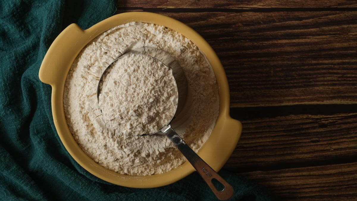 Chapati flour in a bowl with a spoon.