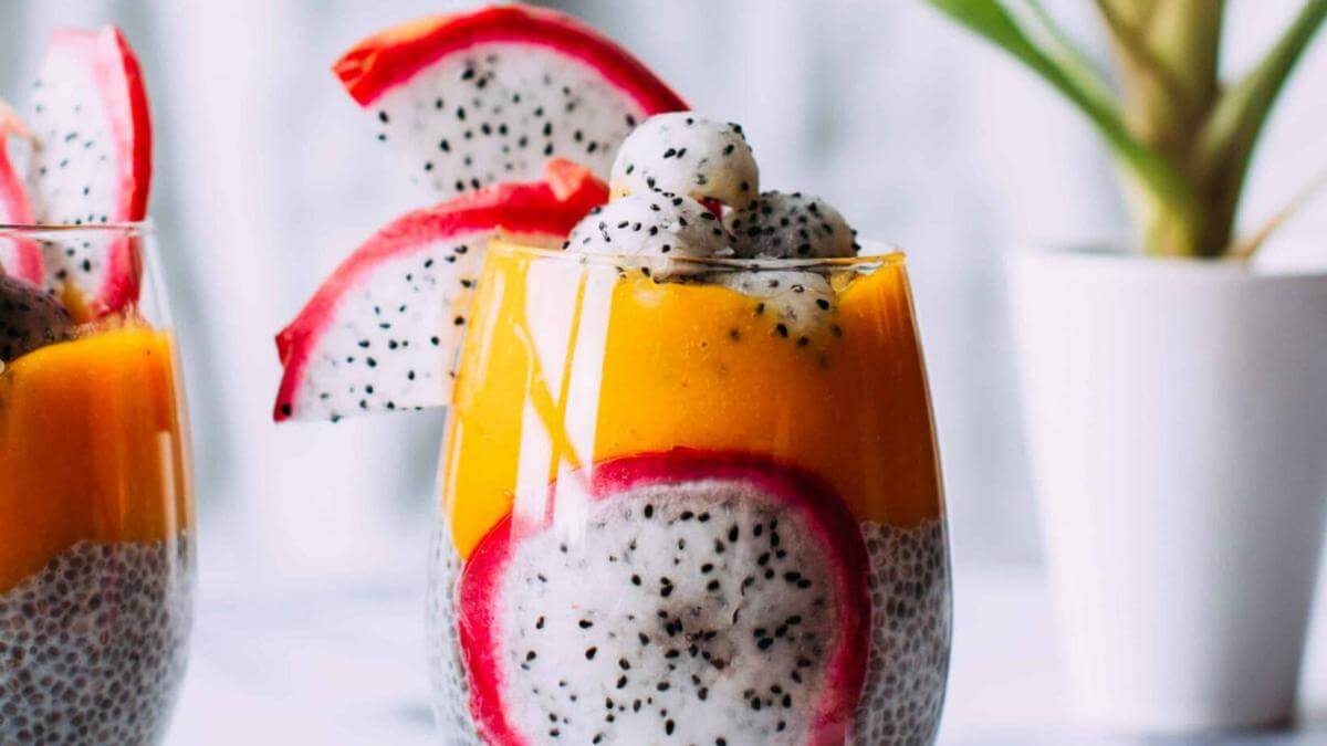 Dragonfruit and mango chia seed pudding in a glass.