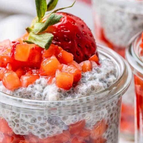 Strawberry layered chia seed pudding in a glass jar.