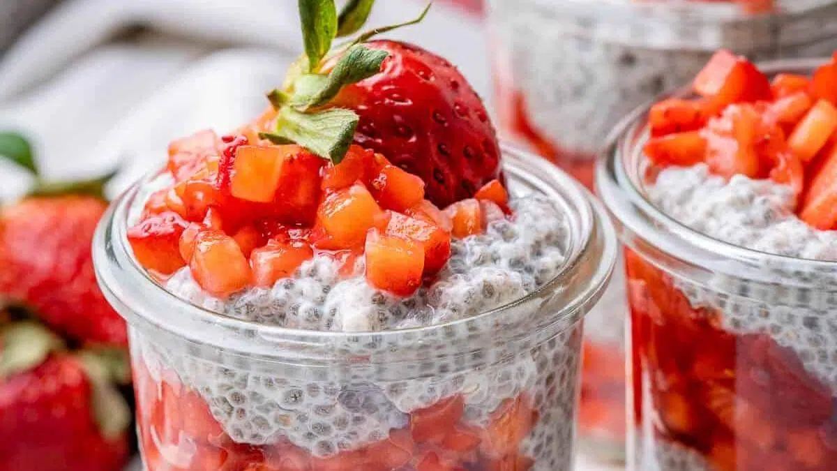Strawberry layered chia seed pudding in a glass jar.