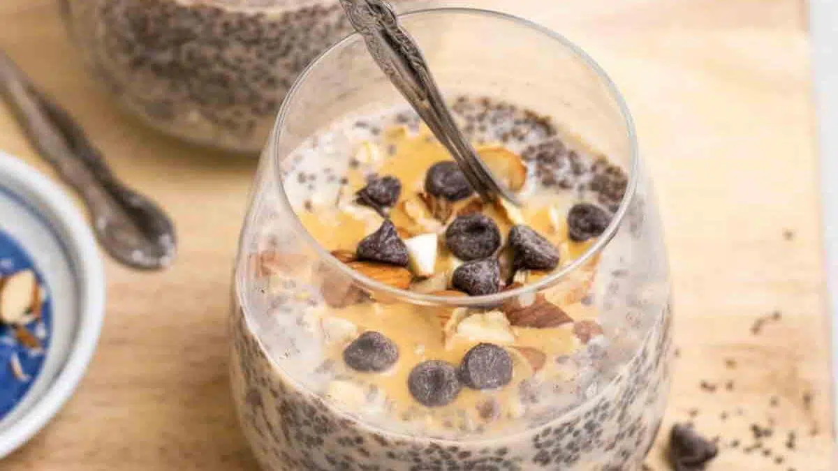 Oatmeal chia seed pudding in a glass topped with chocolate chips.