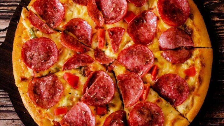 A full pepperoni pizza that has been cut.