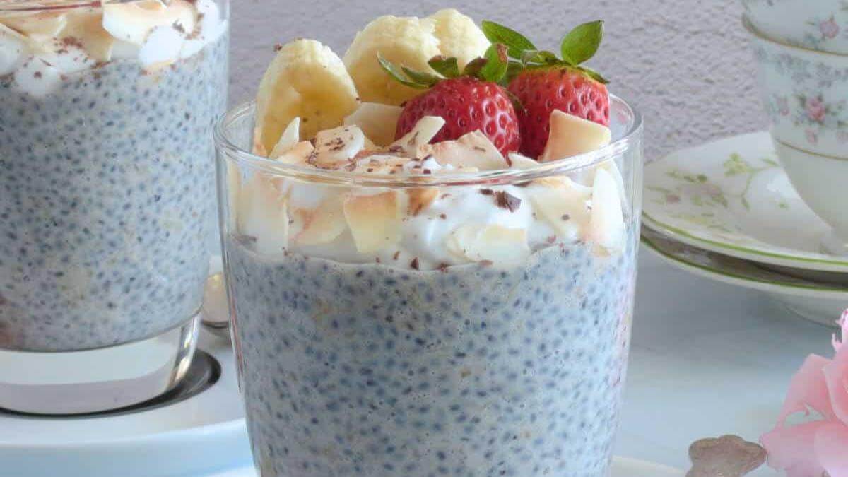Chia seed pudding in a glass topped with bananas and strawberries.