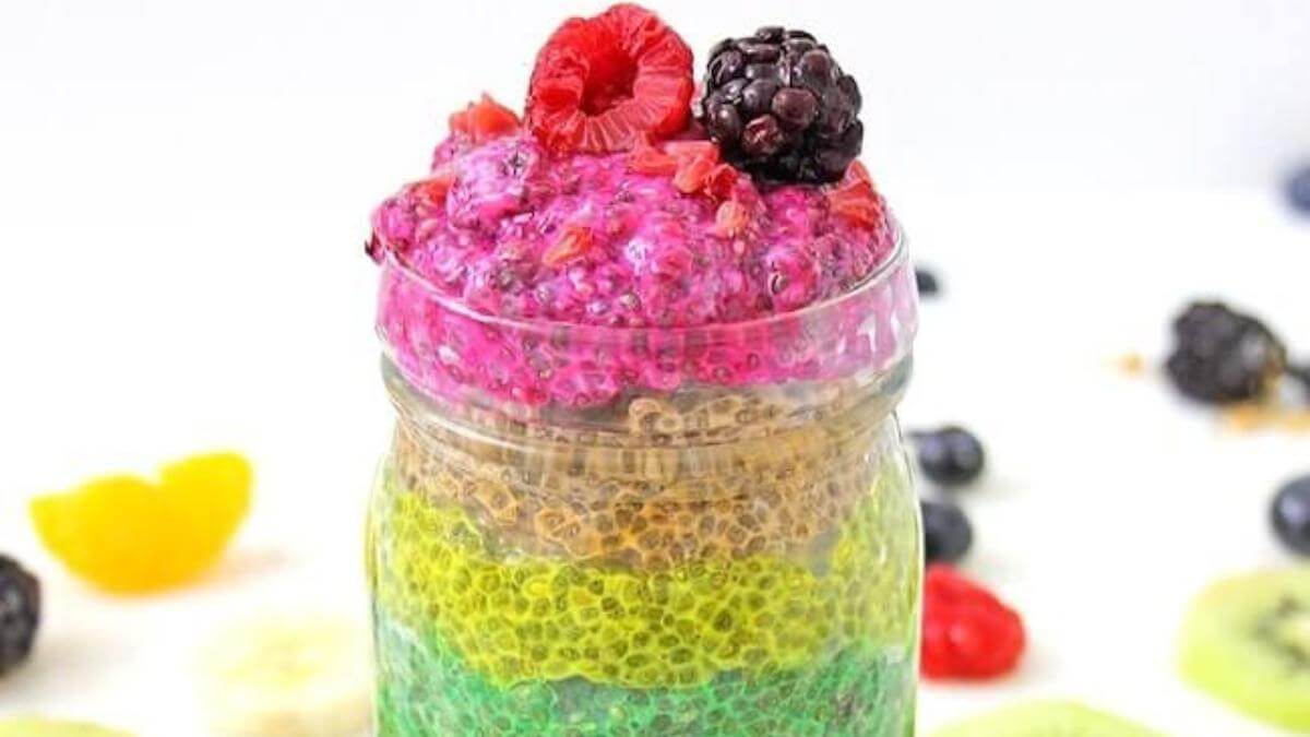 Rainbow layered chia seed pudding in a glass jar.