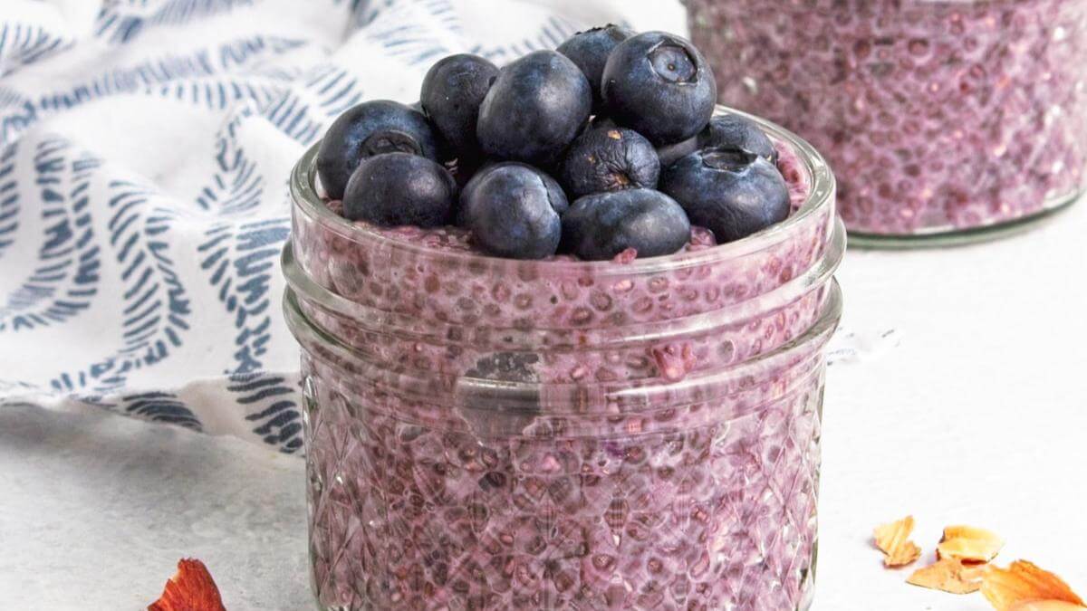 Blueberry chia seed pudding in a glass jar topped with blueberries.