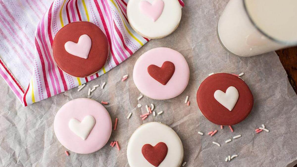 Pink and red frosted cookies with a heart in the middle.