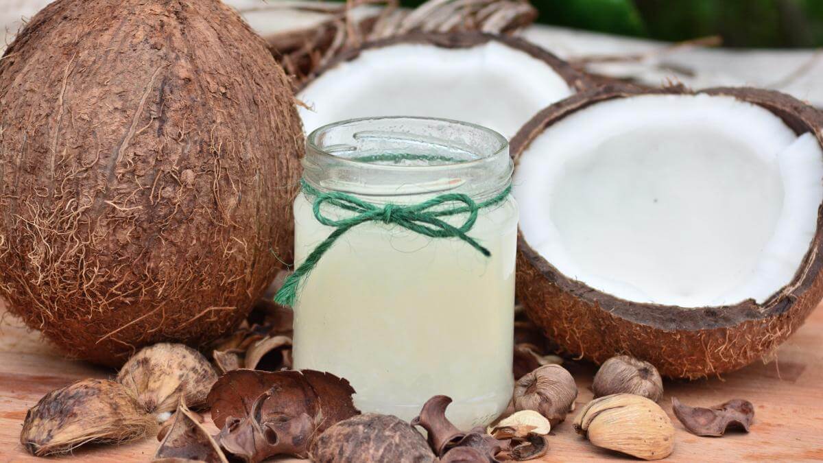 Open coconuts and a jar full of coconut oil.