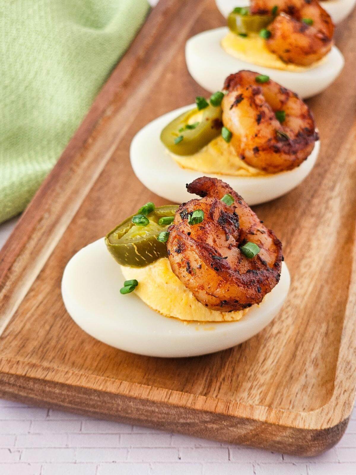 Cajun deviled eggs topped with shrimp and jalapenos.