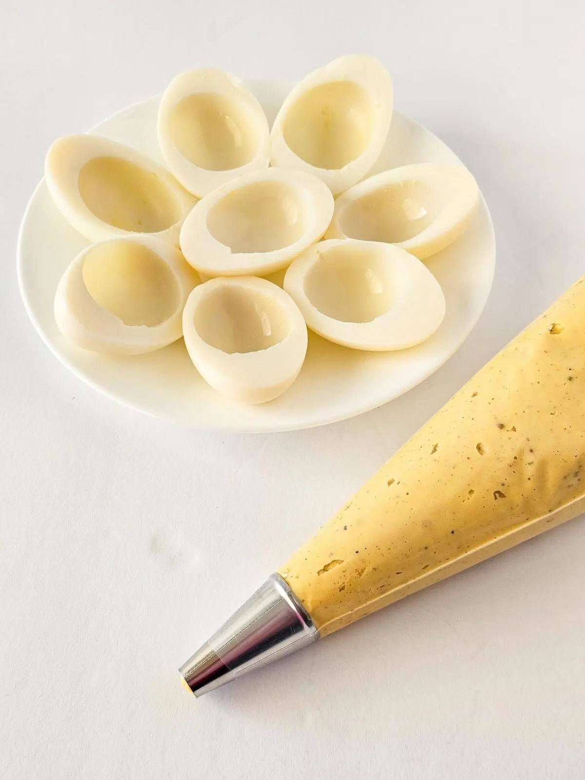 A piping bag filled with Cajun shrimp devlied eggs filling.