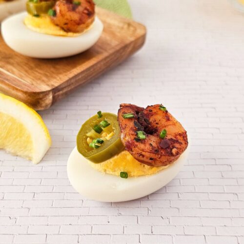 Cajun deviled egg topped with shrimp and jalapeno.