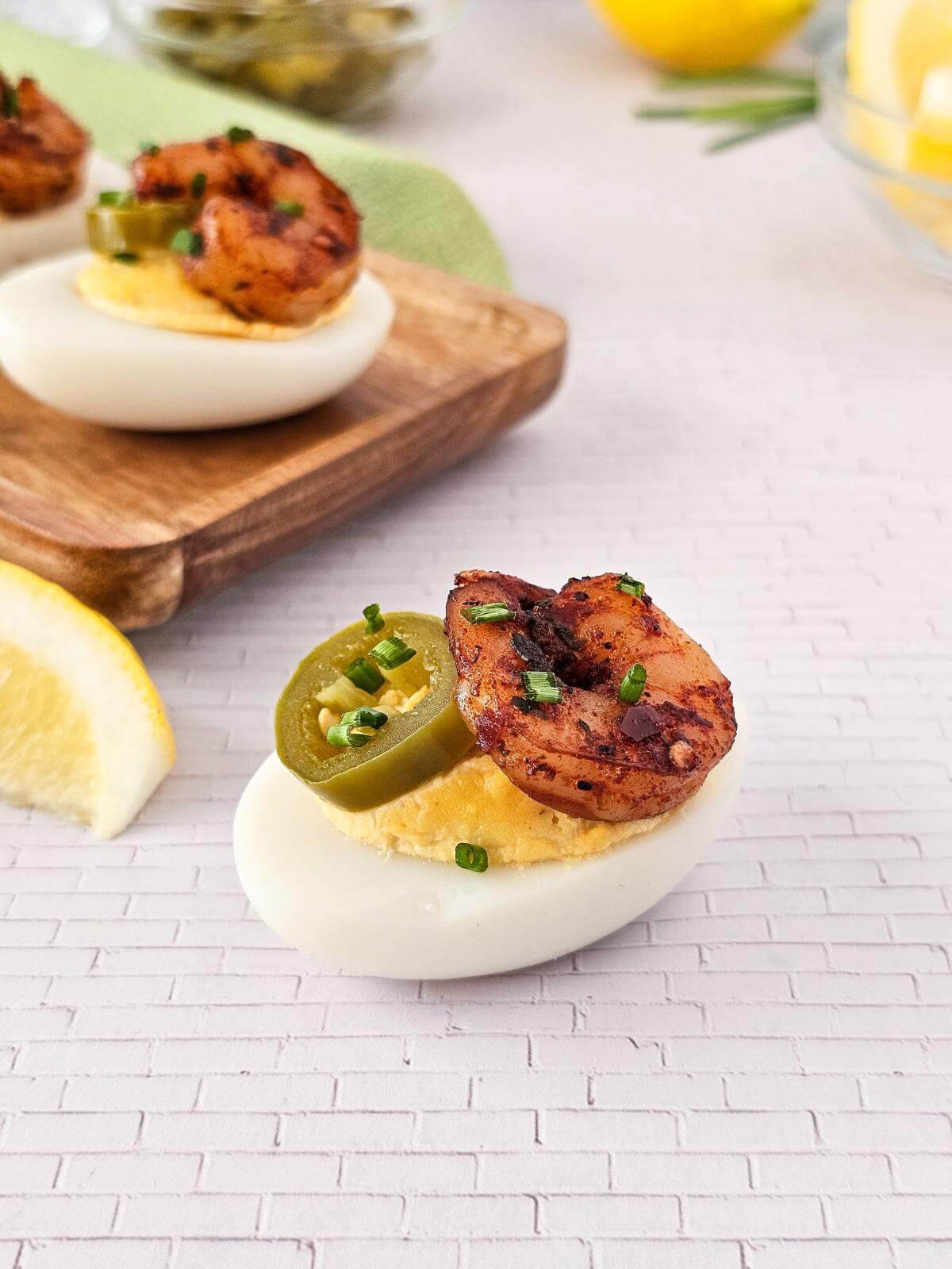 Cajun deviled egg topped with shrimp and jalapeno.