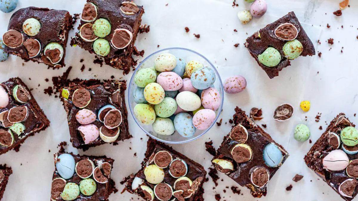 Pieces of Easter mini egg brownies on a table.