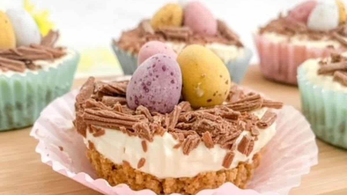 Mini Easter egg cheesecake bites on a table.