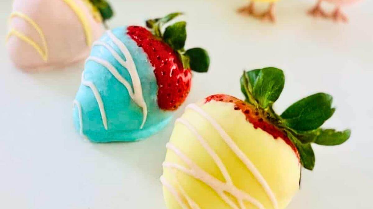 Three colorful chocolate dipped strawberries.