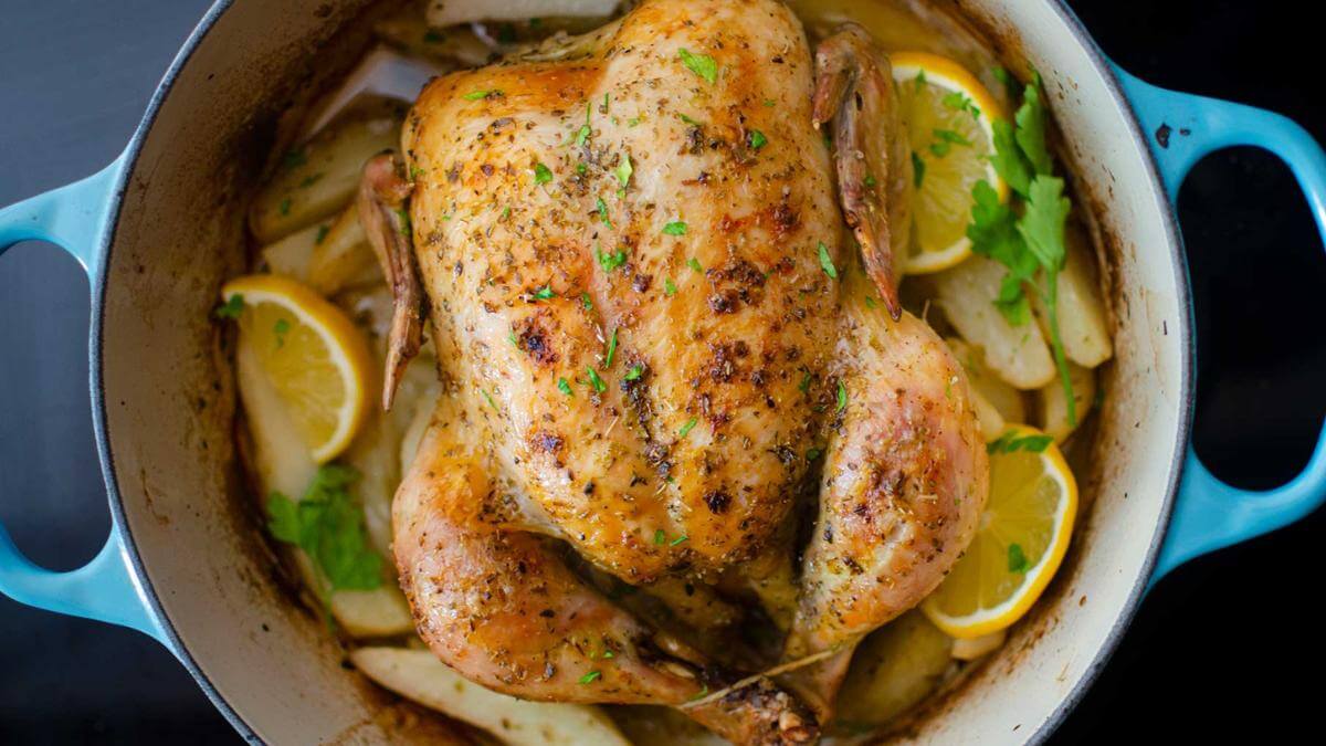 A whole roasted chicken in a dutch oven.