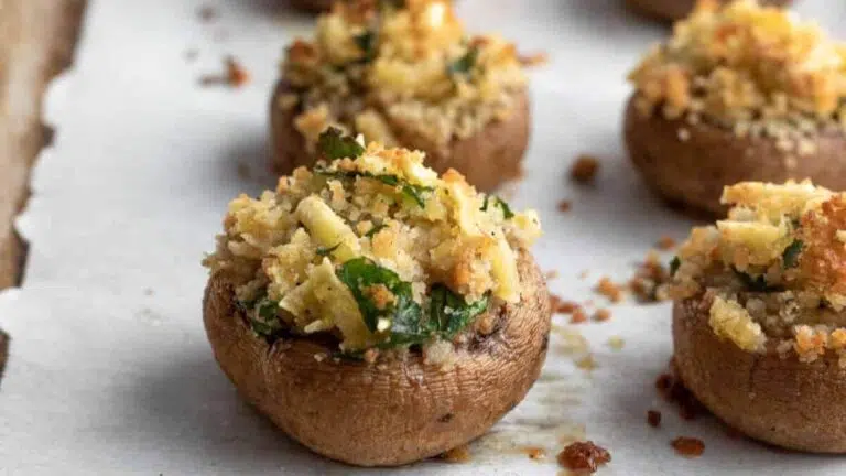 Stuffed mushrooms on parchment paper.
