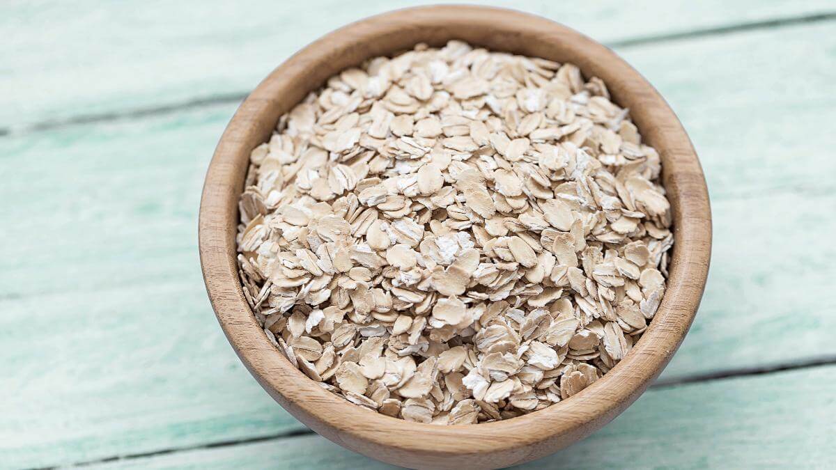 A small wooden bowl full of oats.