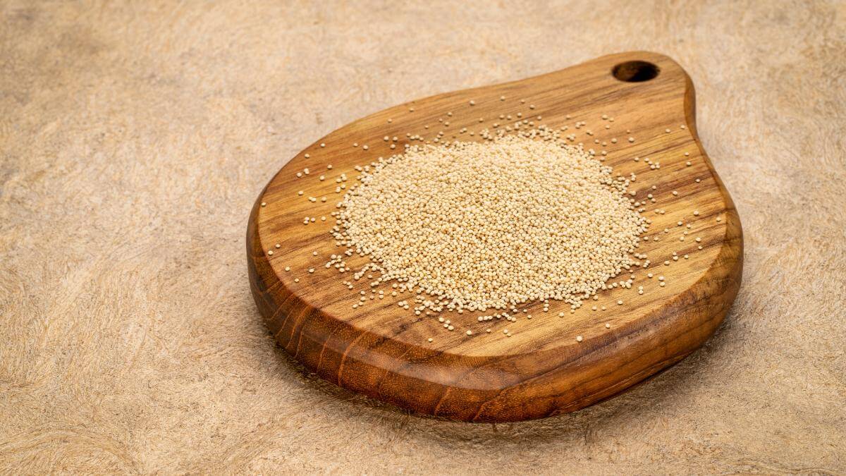 A small pile of Amaranth on rounded wooden board.