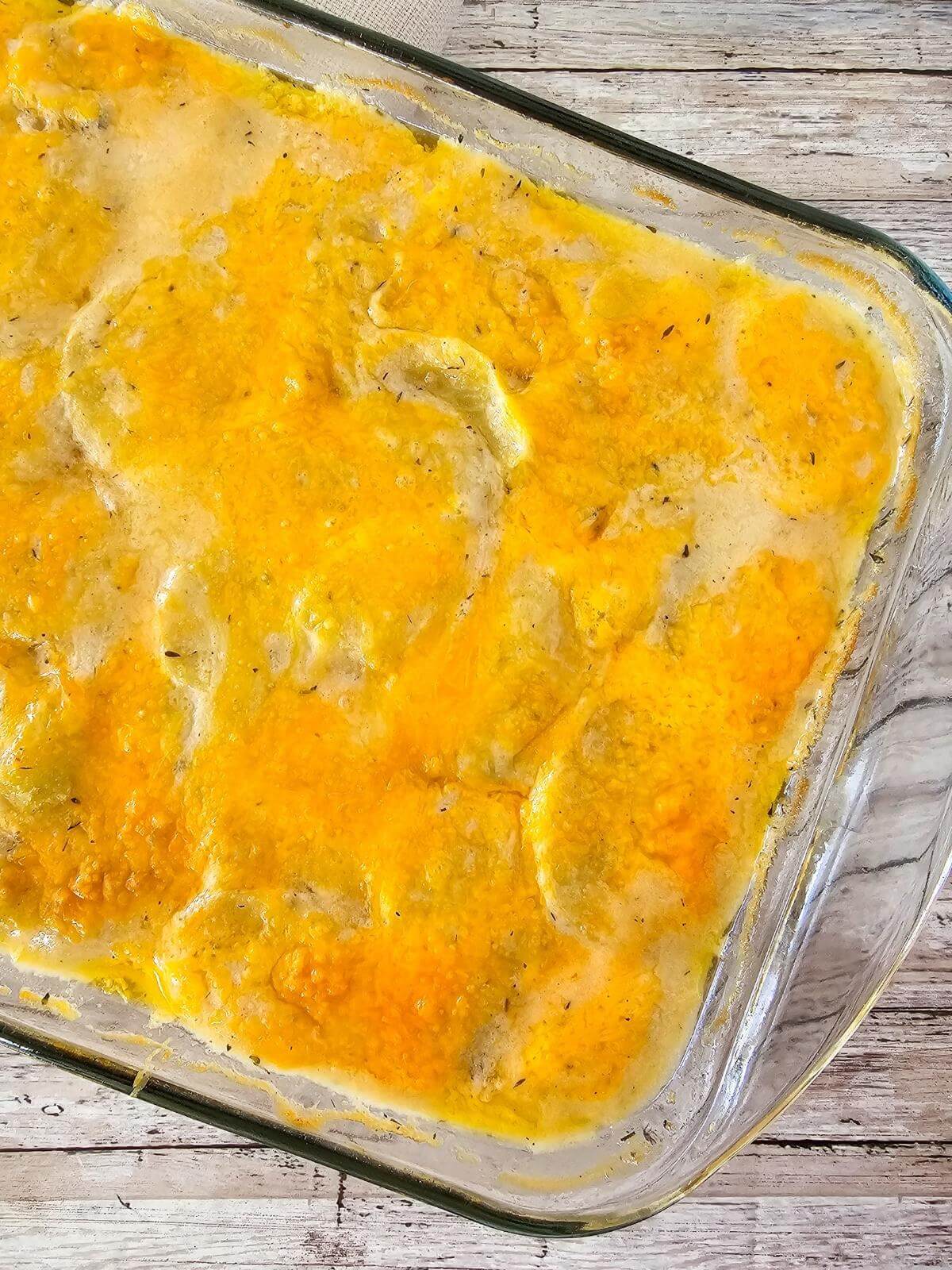 Baked gluten free scalloped potatoes in a casserole dish.